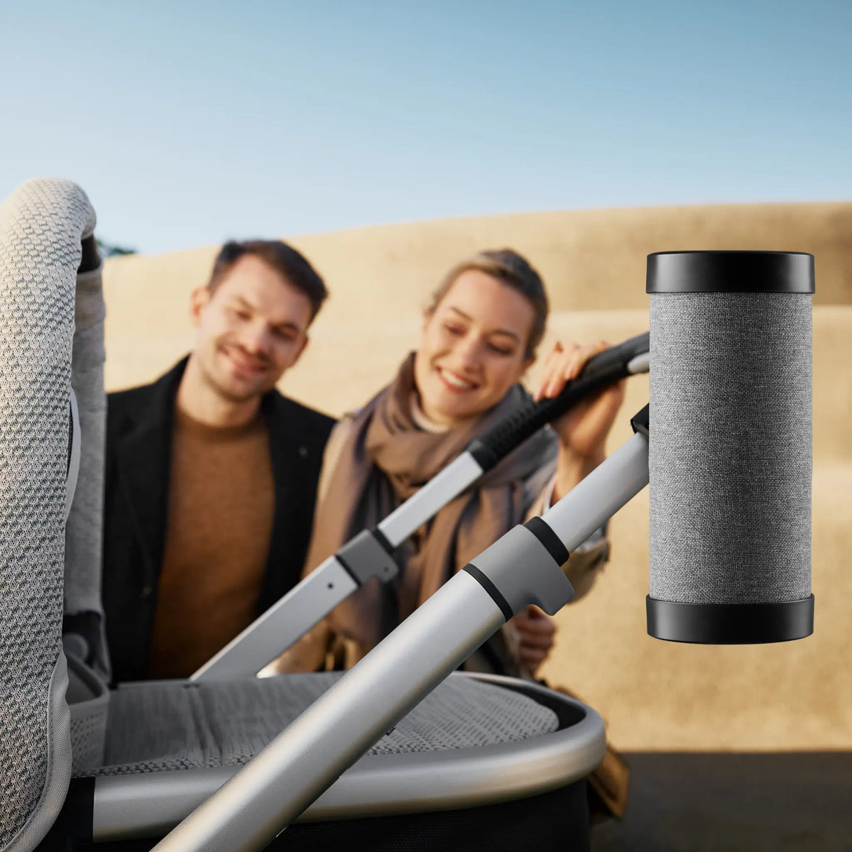 RockingRide device attached to a stroller, with parents smiling in the background.