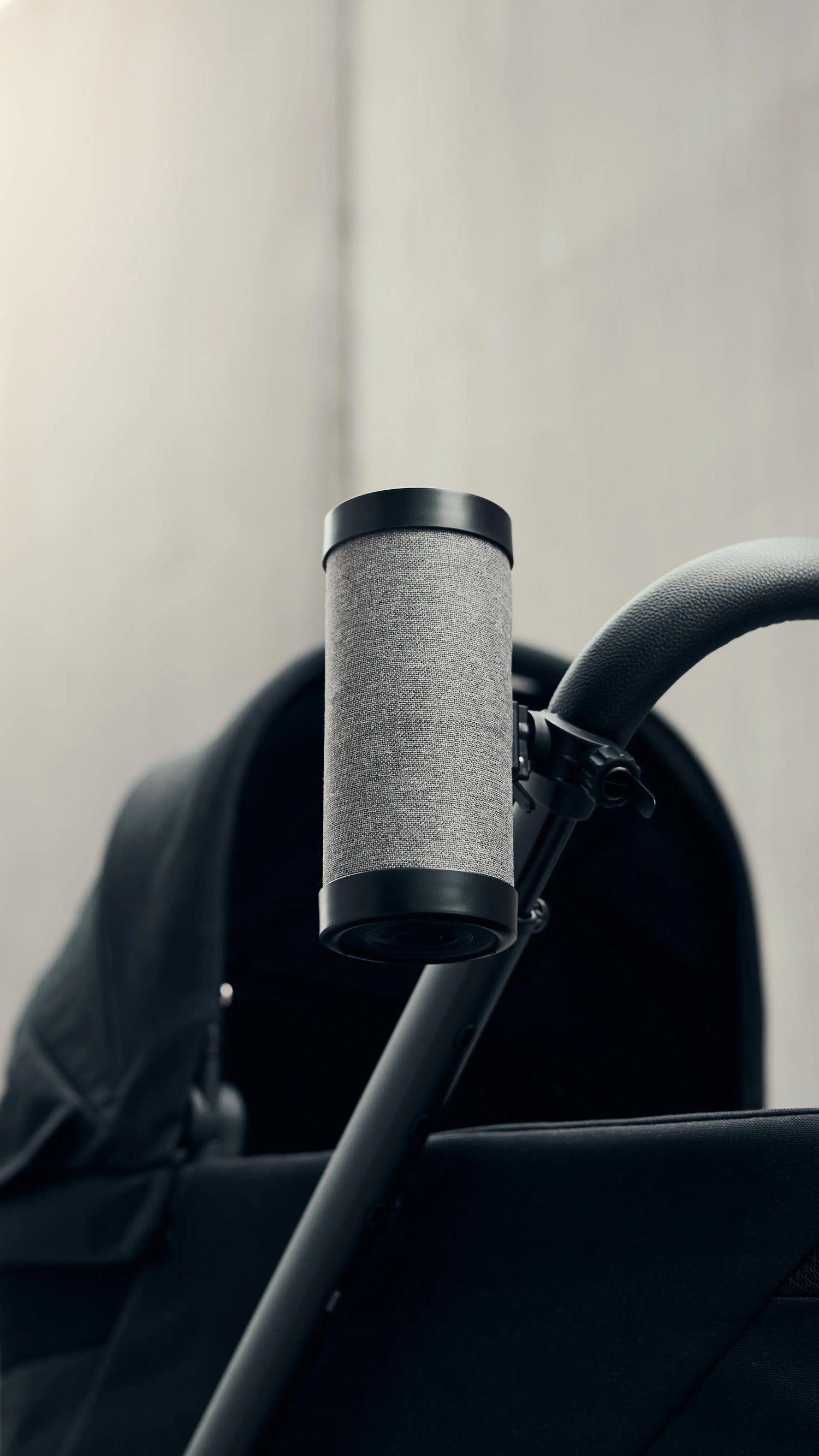 Close-up of the RockingRide® device attached to a stroller, showcasing its sleek and functional design.