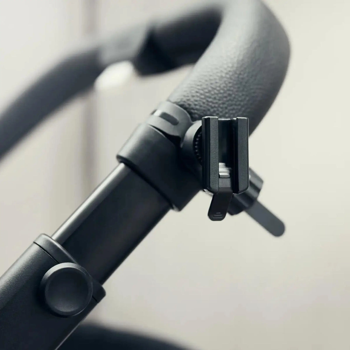 Close-up view of the RockingRide holder securely attached to the stroller handle, showcasing its robust design and easy installation for convenient use.